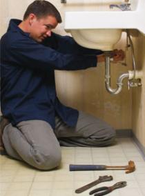 Plumber in Arvada CO repairs a sink drain