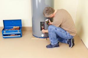 plumber in Arvada CO checks electrical resistence in 40 gallon storage water heater